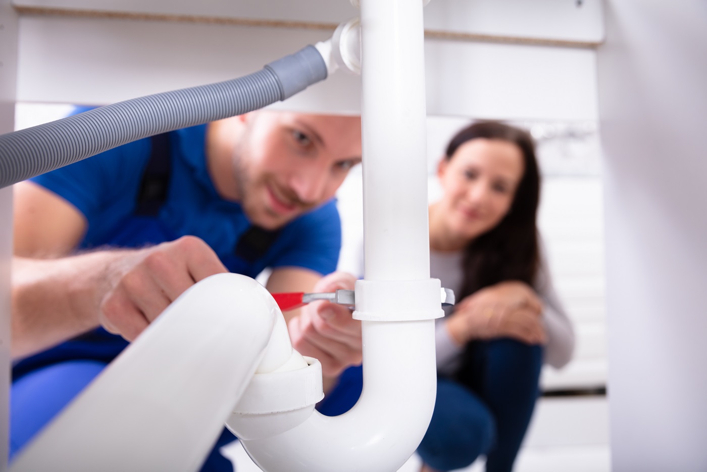 Male Plumber Fixing Sink Pipe