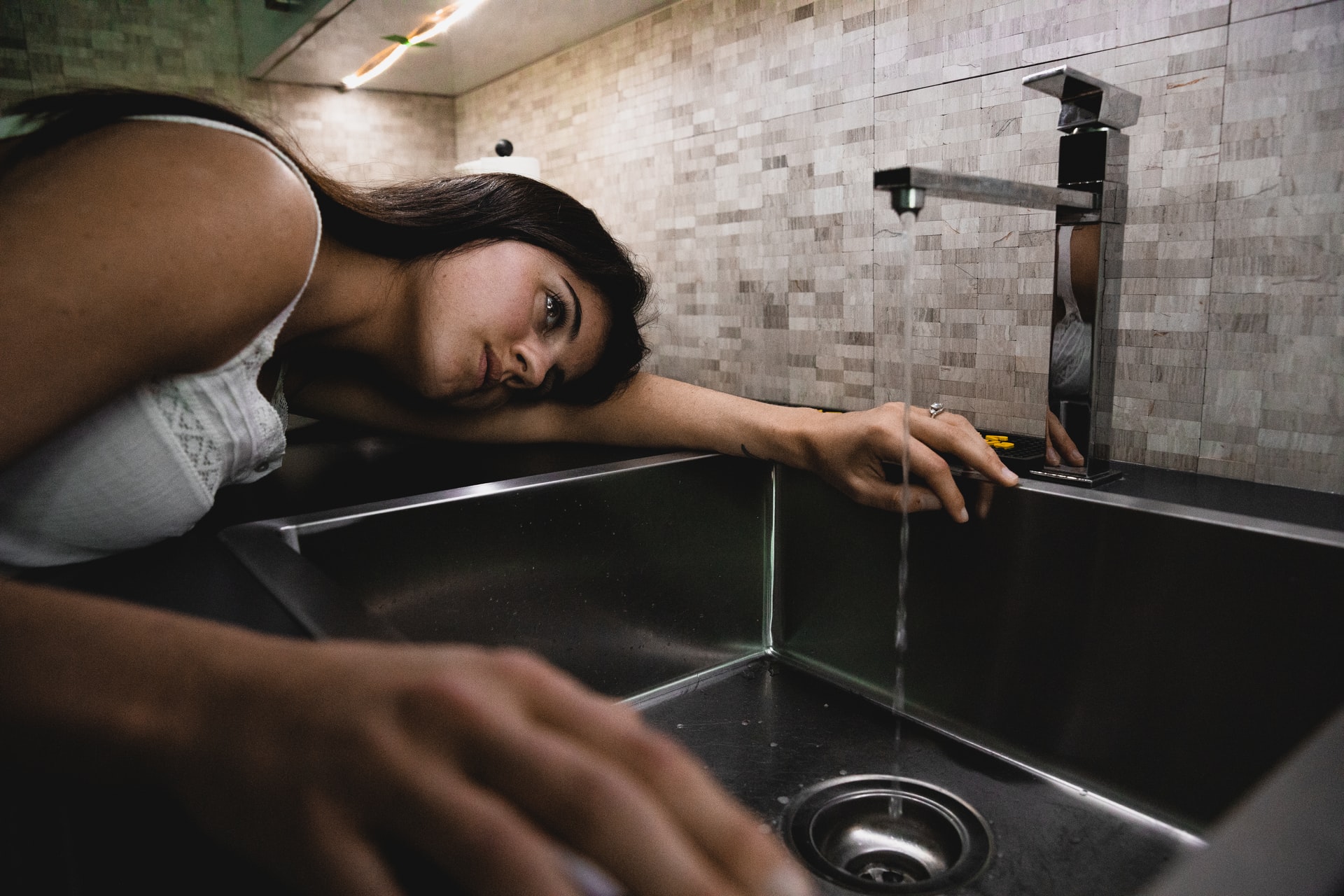 woman inspecting a sink